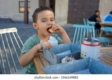 Boy Eating Chicken Nugget With His Hands