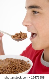 Boy Eating Chocolate Puff Cereal