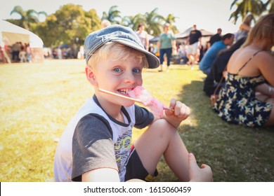 Boy eating fairy floss / cotton candy at local market in Mackay, Queensland Australia