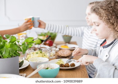 Boy Eating Falafel During Birthday Party At Home. Healthy Diet For Kids