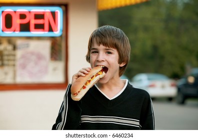 Boy Eating A Footlong Hot Dog