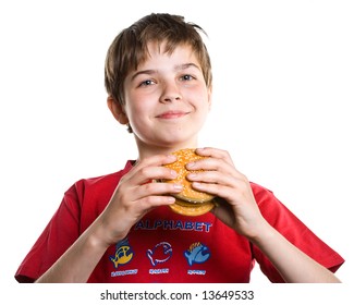 The boy eating a hamburger. Isolated on a white background.