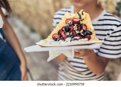 Boy Eating Healthy Fruit Pizza In The Old Town Of Budva, Montenegro.