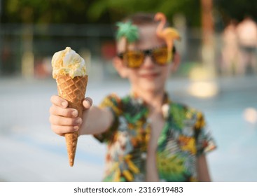 Boy eating ice cream in the pool - Powered by Shutterstock