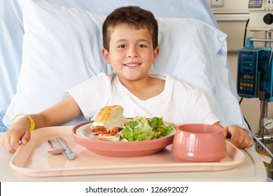 Boy Eating Meal In Hospital Bed