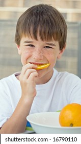 Boy Eating Orange Slice