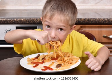 The Boy Is Eating Pasta. Proper Nutrition. A Hungry Child.