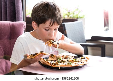 Boy Eating Pizza Italian Restaurant Stock Photo (Edit Now) 707974996