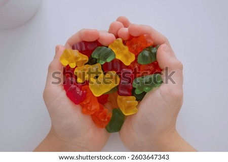 The boy eats jelly beans or takes vitamins.