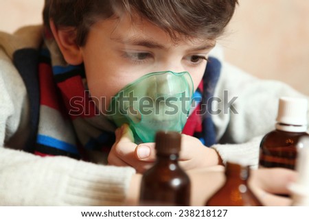 boy with electric inhaler as a curation against virus disease flue
