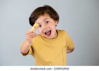 Boy enjoying tequeños, Venezuelan appetizer - Shutterstock ID 2190910943