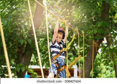 Boy enjoys climbing in the ropes course adventure. - Powered by Shutterstock