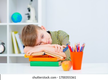 Boy Fallen Asleep On His Book While Studying Late In The Evening