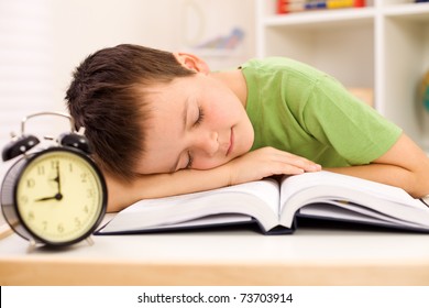 Boy Fallen Asleep On His Book While Studying Late In The Evening