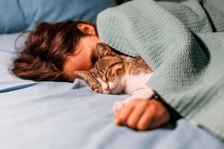 Boy Falls Asleep And Hugs His Cat, Who Sleeps With Him Under The Covers. Children And Pets. The Cat Sleeps With The Baby. The Child Is Getting Ready For Bed.
