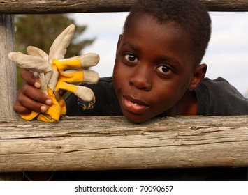 Boy at farm with with work gloves