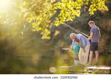 Boy, Father And Grandfather Fishing In Lake