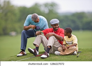 Boy with Father and Grandfather on golf course