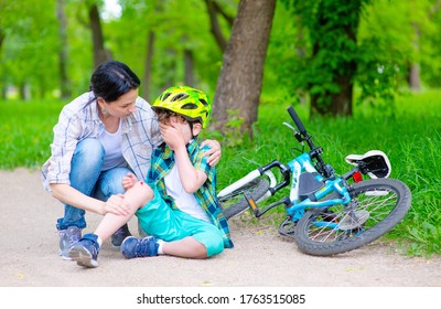 The Boy Fell Off The Bike And Cries, Mom Calms The Sobbing Child