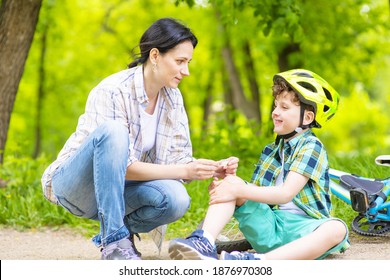 The Boy Fell Off The Bike And Cries, Mom Calms The Sobbing Child