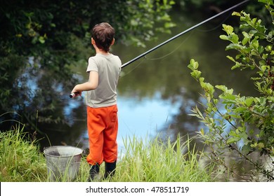 Boy Fishing Near A Small River.