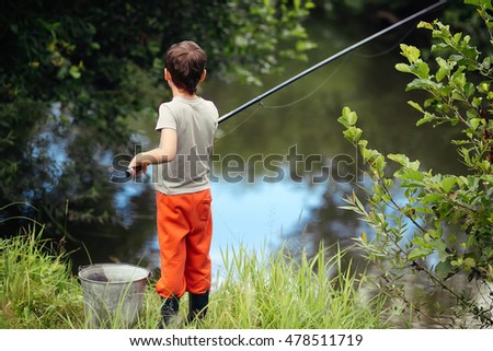 Boy fishing near a small river.