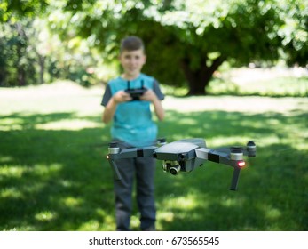 Boy Flying Quad Copter Drone In A Park