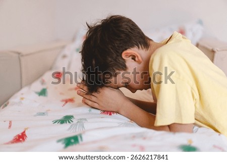 A boy with folded hands in front of him, he is praying or meditating. Concept of Christianity, religion and faith.
