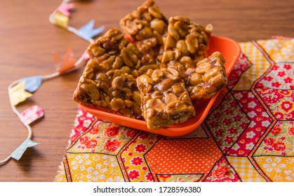 Boy Foot or "Pé de Moleque" is a Peanut candy tipical in Festa Junina Festival. Traditional food of Brazil, June Party sweet. Arraial Rustic Wood Background.
