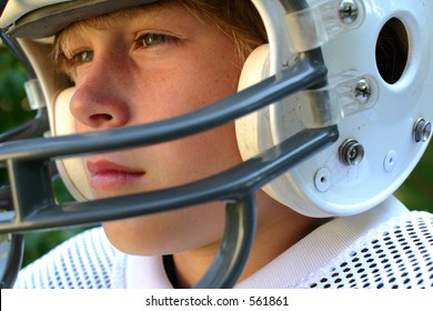 Boy In Football Helmet Contemplating The Game