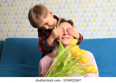 the boy gave flowers to his mother and hugs her. mother's day concept