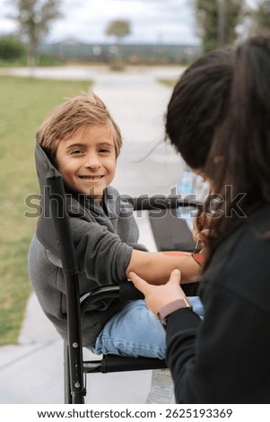 Boy getting a hand paint and facepaint