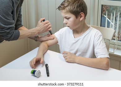 Boy Getting Insulin After Measuring Glucose Or Blood Suger Level