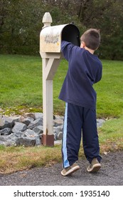 Boy Getting Mail From Mailbox