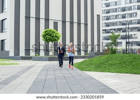 Boy and girl with backpack behind back. Back to school. Children go to school for study. Beginning of school lessons. Foto stock © 