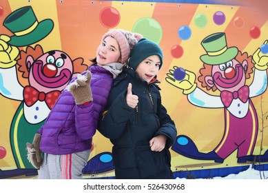 Boy And Girl Brother And Sister On The Circus Gate With Clown Background Smile Happy