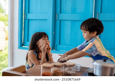 Boy and girl covered in flour making a mess and having fun while baking in the kitchen - Powered by Shutterstock