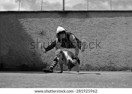 Boy and girl dancing break dance on the street