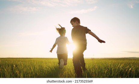 boy girl and dog a running in the park. happy family kid dream holiday concept. children hold hands brother sister run across the field silhouette summer in the park. kids run sun