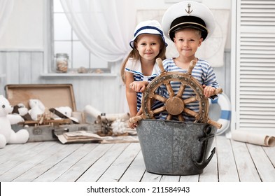 Boy and girl dressed as a captain and sailors played on the ship out of the bath in his room - Shutterstock ID 211584943