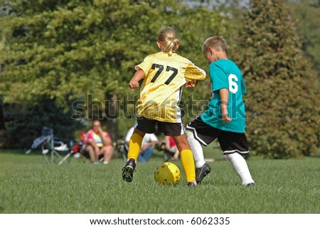 Boy and Girl Fight for Soccer Ball Foto stock © 