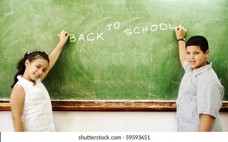 Boy and girl in front of school board writing: BACK TO SCHOOL - Powered by Shutterstock