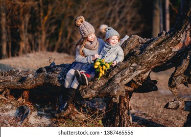 A Boy And A Girl  Having Fun Outside In Early Spring In The Forest Near The Water. A Sister And Brothe Together. Friendship And  Family Concept