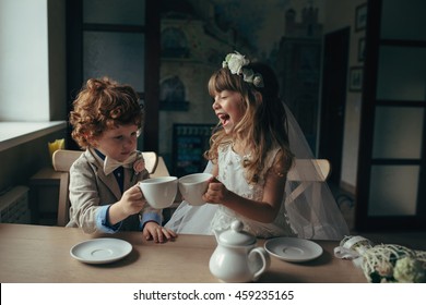 Boy And Girl Having Tea Party In Cafe