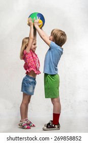 Boy And Girl Holding A Ball