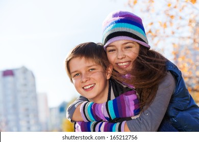 Boy And Girl Hugging And Smiling 10 And 11 Years Old Wearing Warm Autumn Clothes Outside