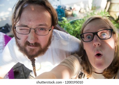 A Boy And A Girl Making Silly Faces And Taking A Selfie