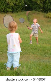 boy and girl play badminton
