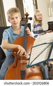 Boy And Girl Playing Cello And Piano At Home