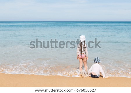 boy and girl playing wave on beach and beautiful ocean
